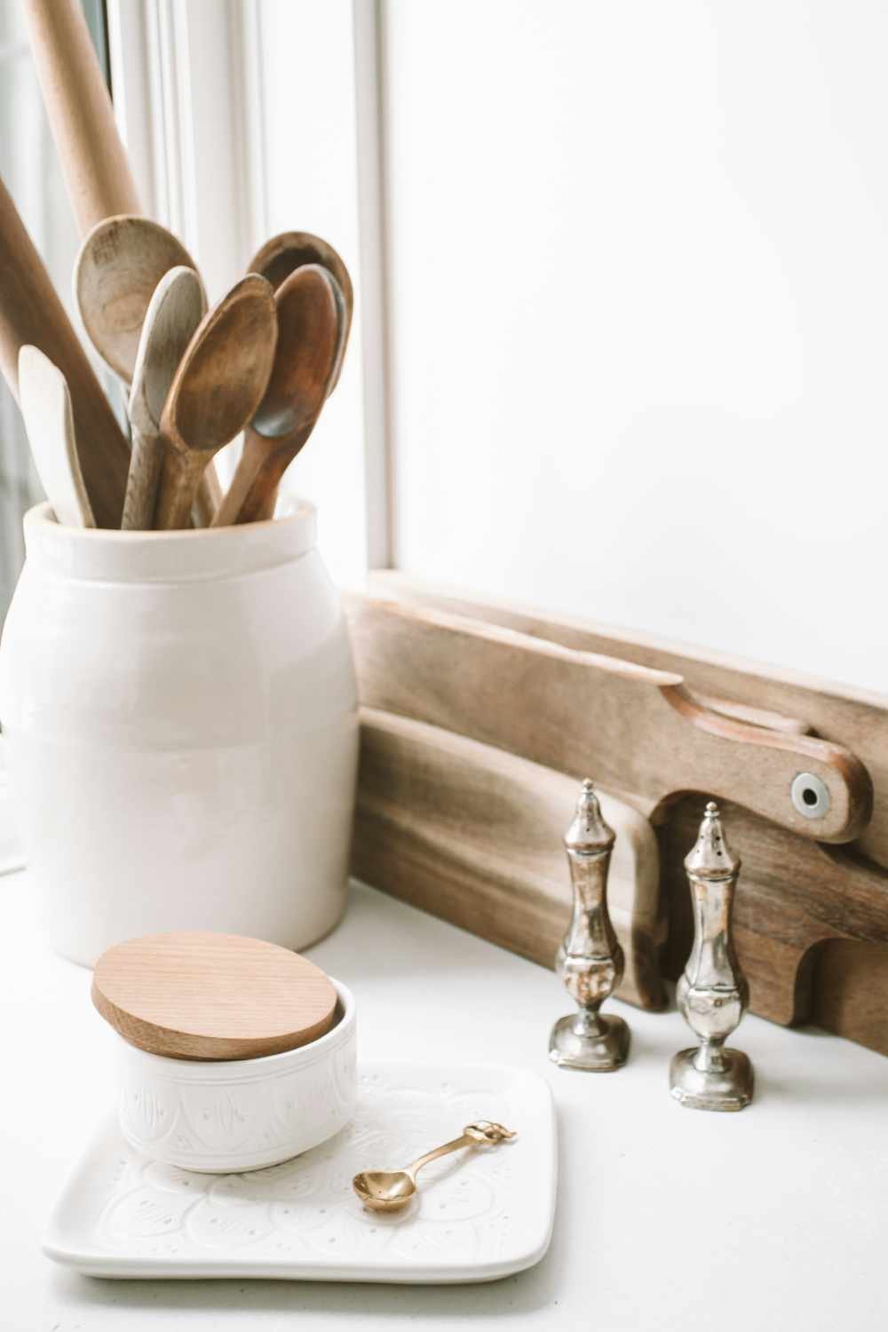 an image of a white container of wooden spoons
